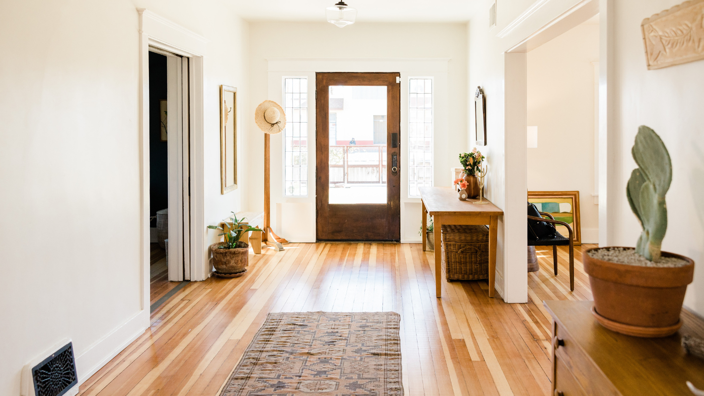 A hallway with a wooden floor and a door